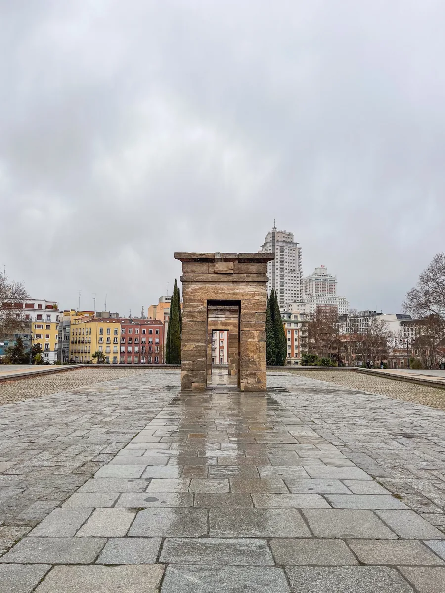 temple of debod in Madrid with ancient egyptian stone arches in the middle of a stone walkway.